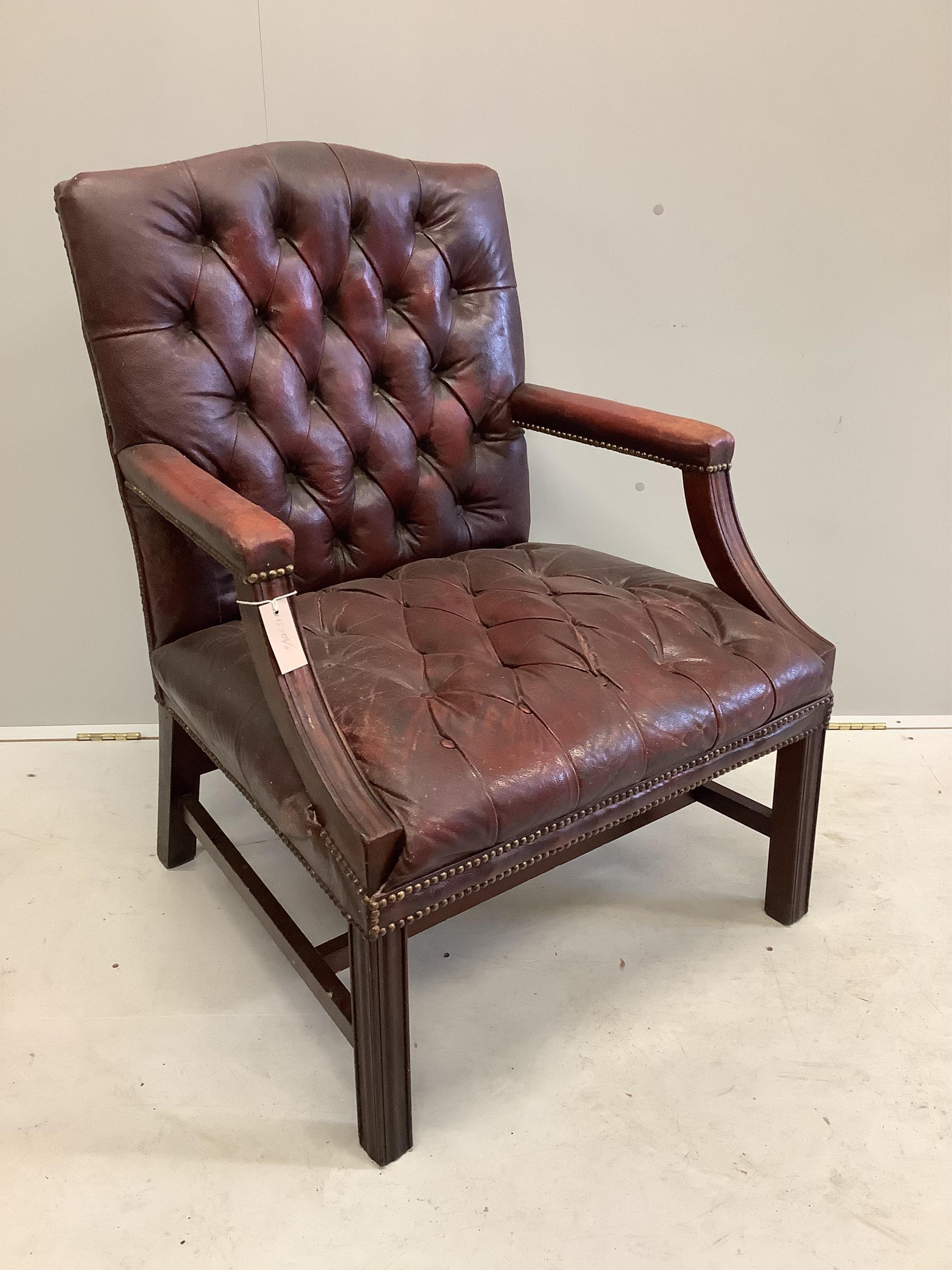 A George III style buttoned leather Gainsborough style chair, width 70cm, depth 61cm, height 94cm. Condition - fair